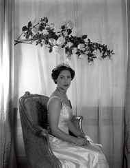 Princess Margaret sitting under a branch of roses