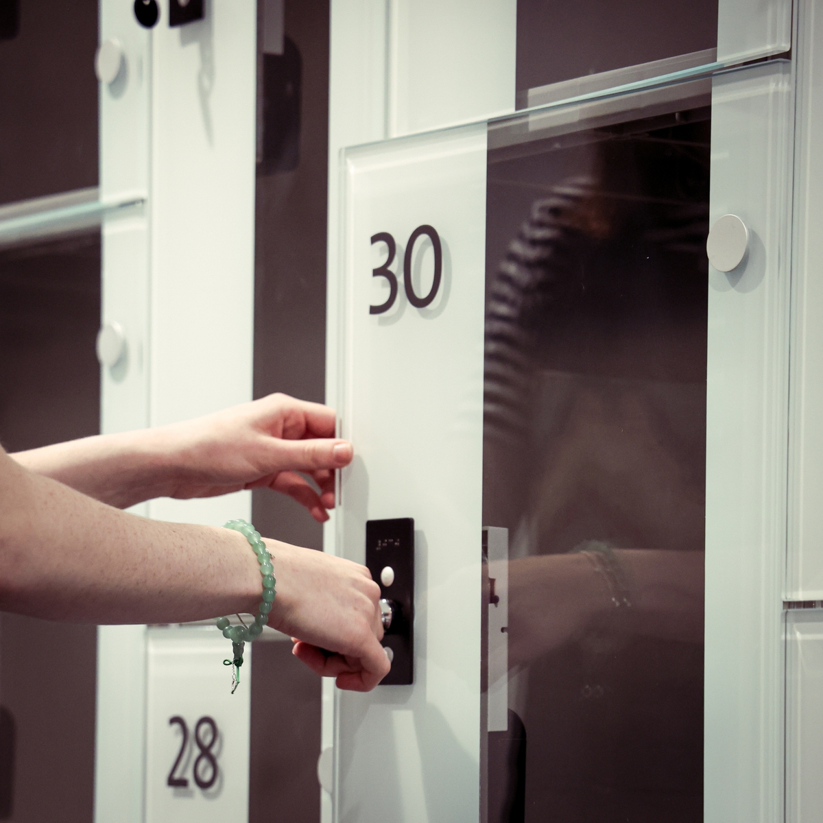 A woman opening a locker at V&A Dundee
