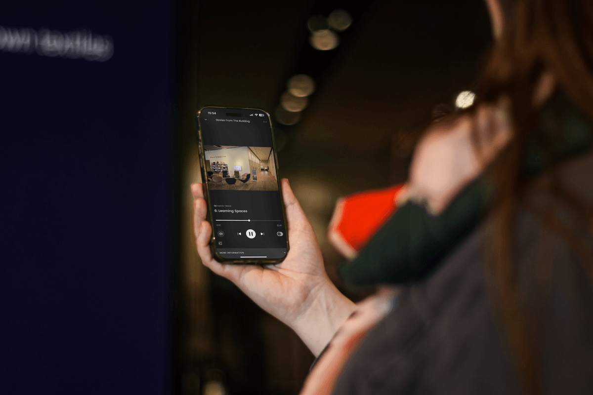 A woman holding a smartphone, using the Smartify app in V&A Dundee